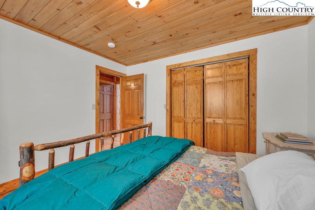 198 Laurel Hill Lane Boone, NC 28607 - Photo 28 of 50 a bedroom with a bed and a window