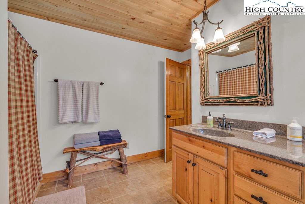 198 Laurel Hill Lane Boone, NC 28607 - Photo 29 of 50 a spacious bathroom with a double vanity sink and a mirror
