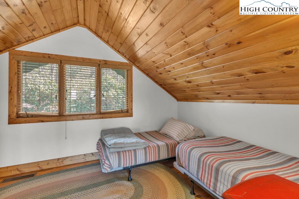 198 Laurel Hill Lane Boone, NC 28607 - Photo 36 of 50 a bedroom with bed and a large window