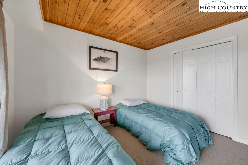 198 Laurel Hill Lane Boone, NC 28607 - Photo 45 of 50 a bedroom with a bed and a painting on the wall