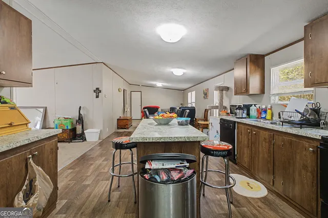 a open kitchen with stainless steel appliances granite countertop a stove and a refrigerator