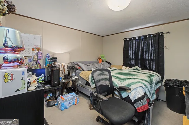 a bed room with a bed a closet and a window