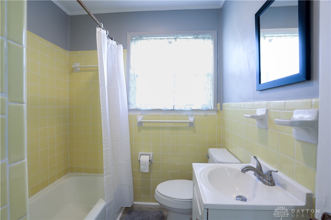 1627 Joselin Road Dayton, OH 45432 - Photo 25 of 28 Bright and functional bathroom with classic tiled walls and essential fixtures.