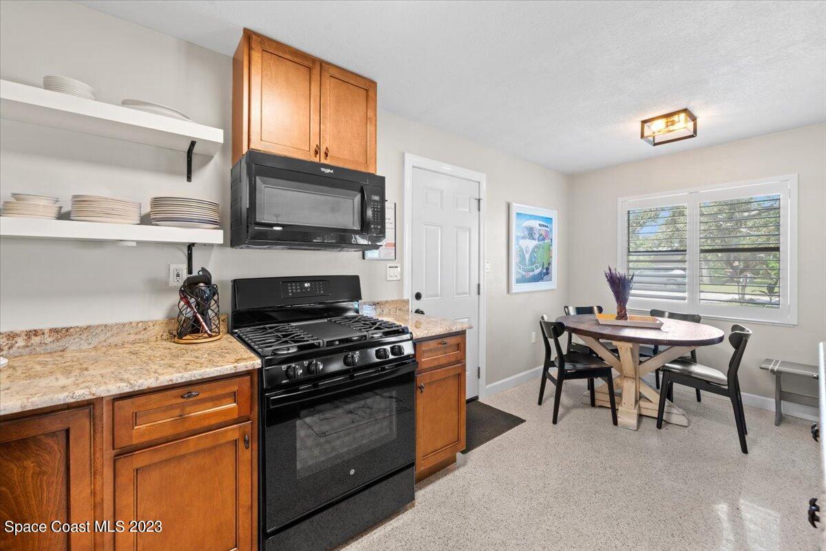 550 Capri Road Cocoa Beach, FL 32931 - Photo 12 of 36 a kitchen with a stove and a table