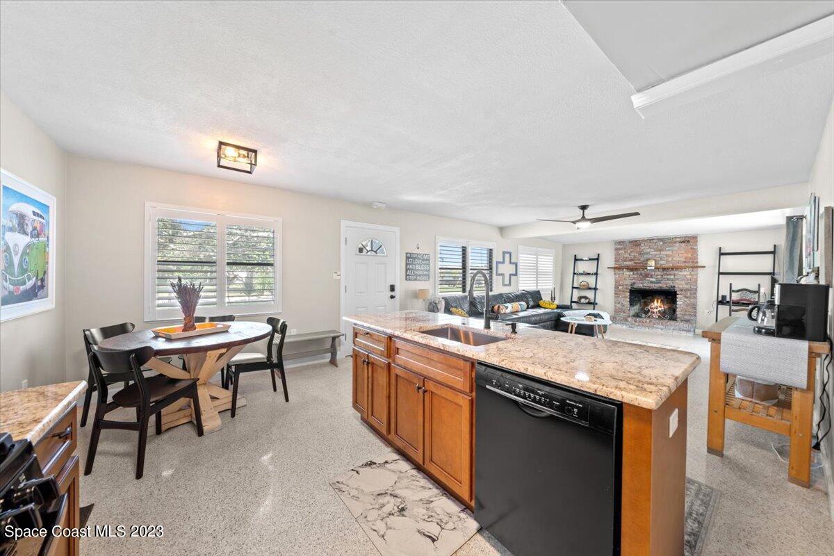 550 Capri Road Cocoa Beach, FL 32931 - Photo 13 of 36 a large kitchen with kitchen island a sink table and chairs