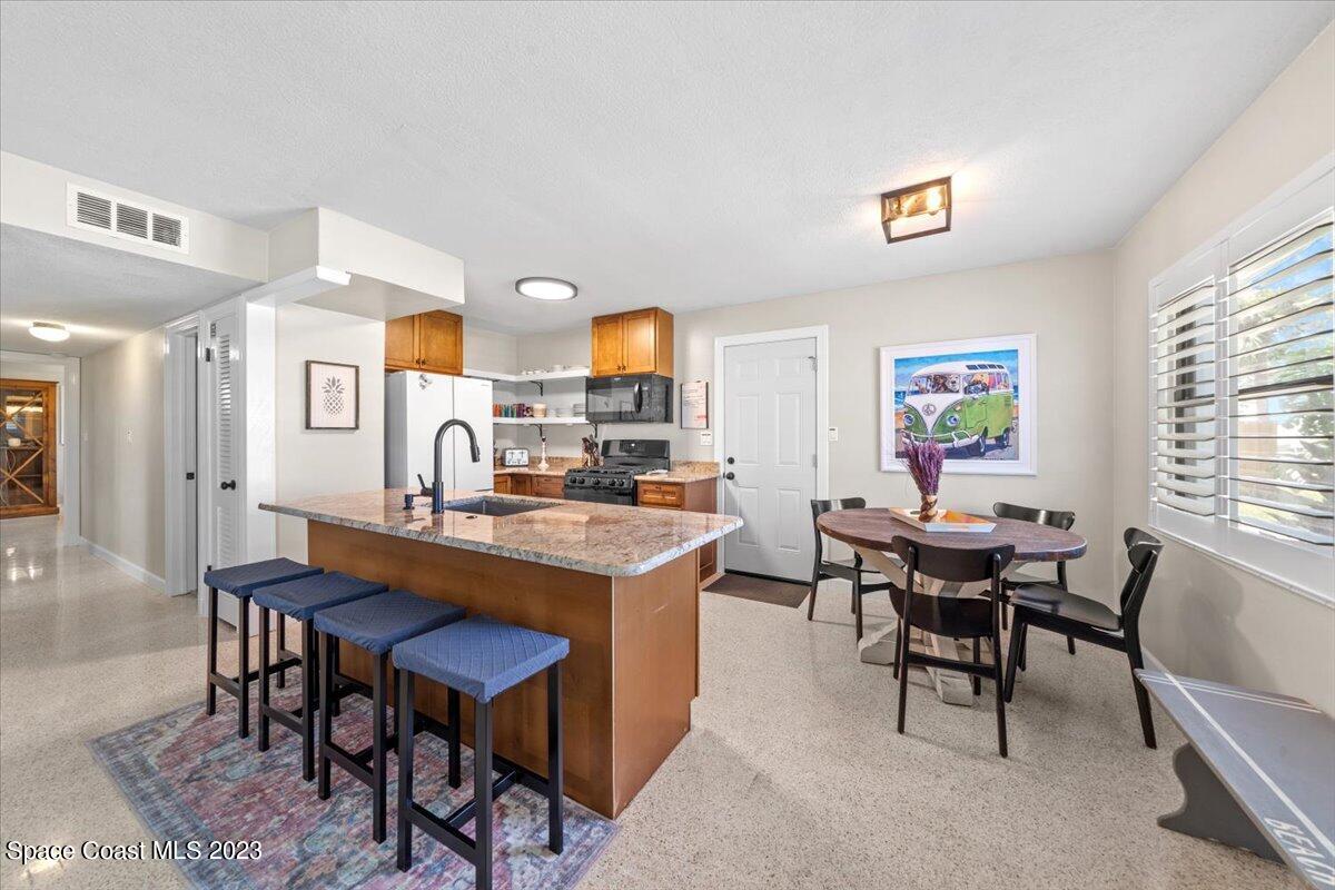 550 Capri Road Cocoa Beach, FL 32931 - Photo 15 of 36 a view of a dining room with furniture and a window