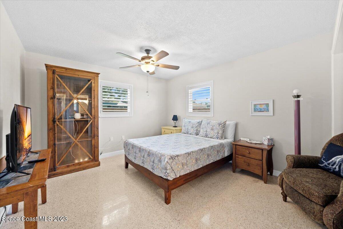 550 Capri Road Cocoa Beach, FL 32931 - Photo 16 of 36 a bedroom with a bed couch and a window