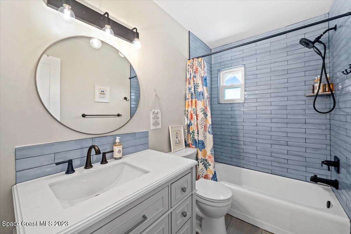 550 Capri Road Cocoa Beach, FL 32931 - Photo 19 of 36 a bathroom with a sink a toilet and a mirror