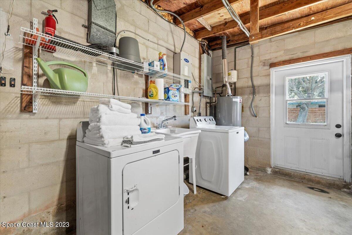 550 Capri Road Cocoa Beach, FL 32931 - Photo 23 of 36 a utility room with dryer and washer