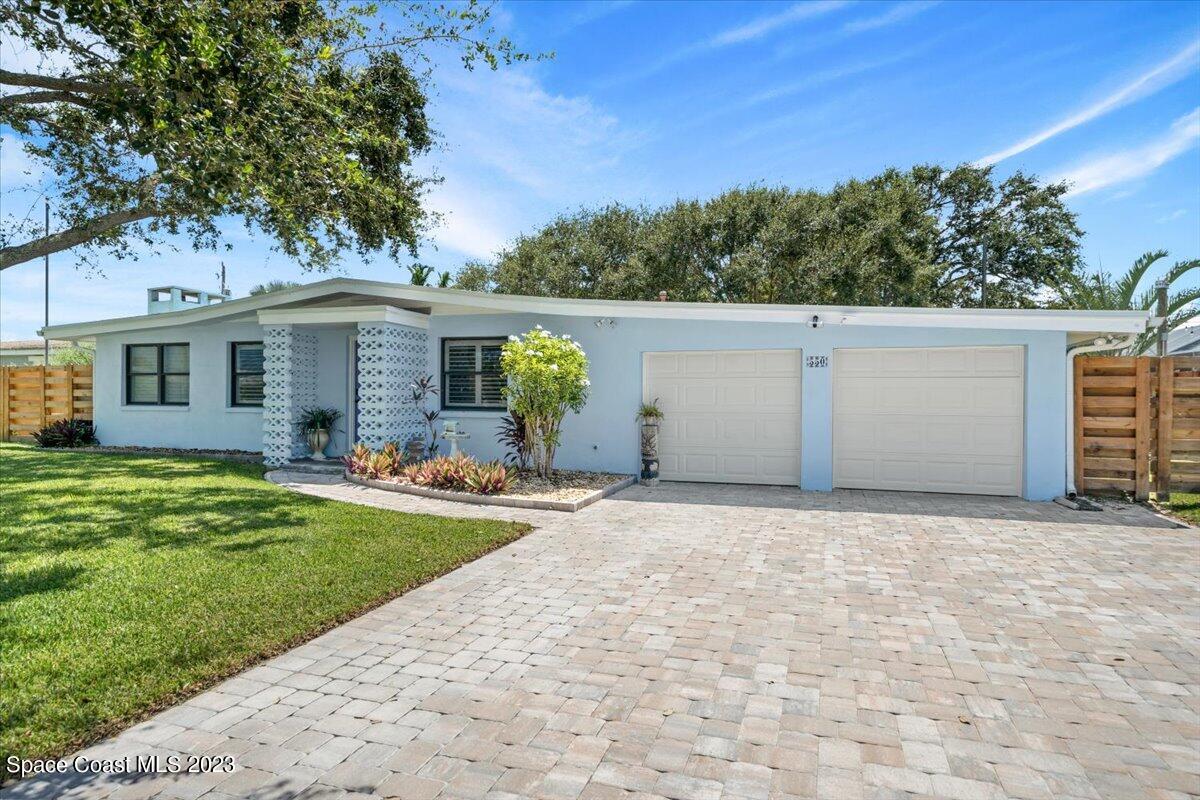 550 Capri Road Cocoa Beach, FL 32931 - Photo 4 of 36 front view of a house with a yard