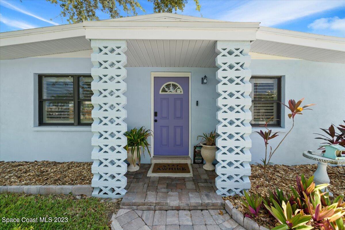 550 Capri Road Cocoa Beach, FL 32931 - Photo 5 of 36 a front view of a house with a tree