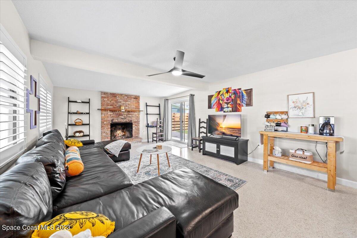 550 Capri Road Cocoa Beach, FL 32931 - Photo 6 of 36 a living room with furniture and a flat screen tv