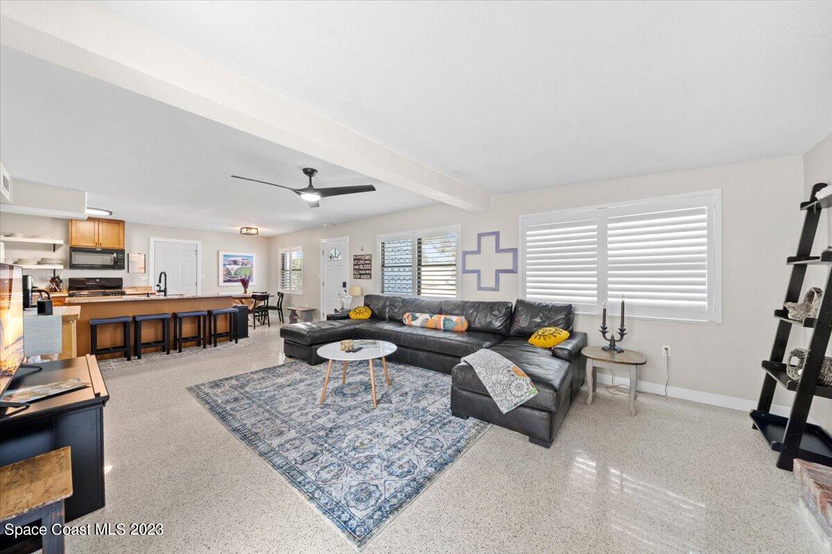 550 Capri Road Cocoa Beach, FL 32931 - Photo 8 of 36 a living room with furniture and a flat screen tv