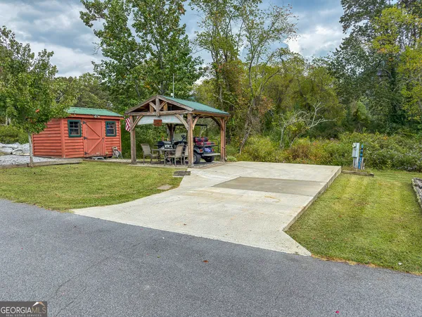 a view of a house with pool and yard