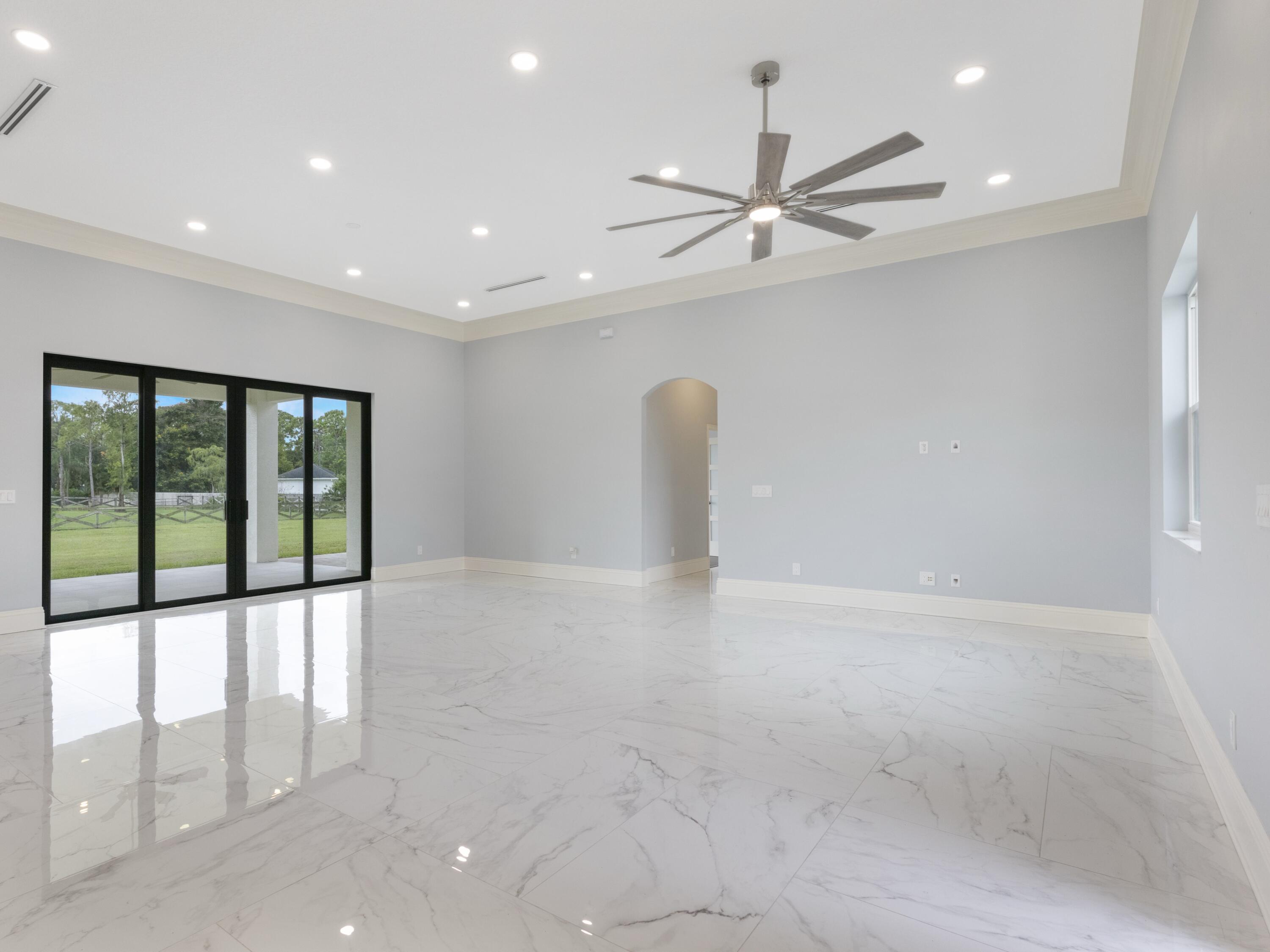 17436 71st Lane North Loxahatchee, FL 33470 - Photo 23 of 50 a view of a livingroom with a ceiling fan and window