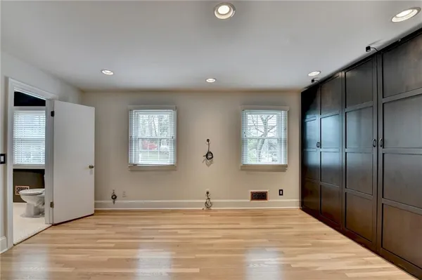 a view of a room with wooden floor and windows