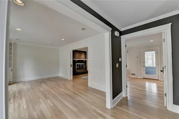 a view of a hallway with wooden floor and stairs