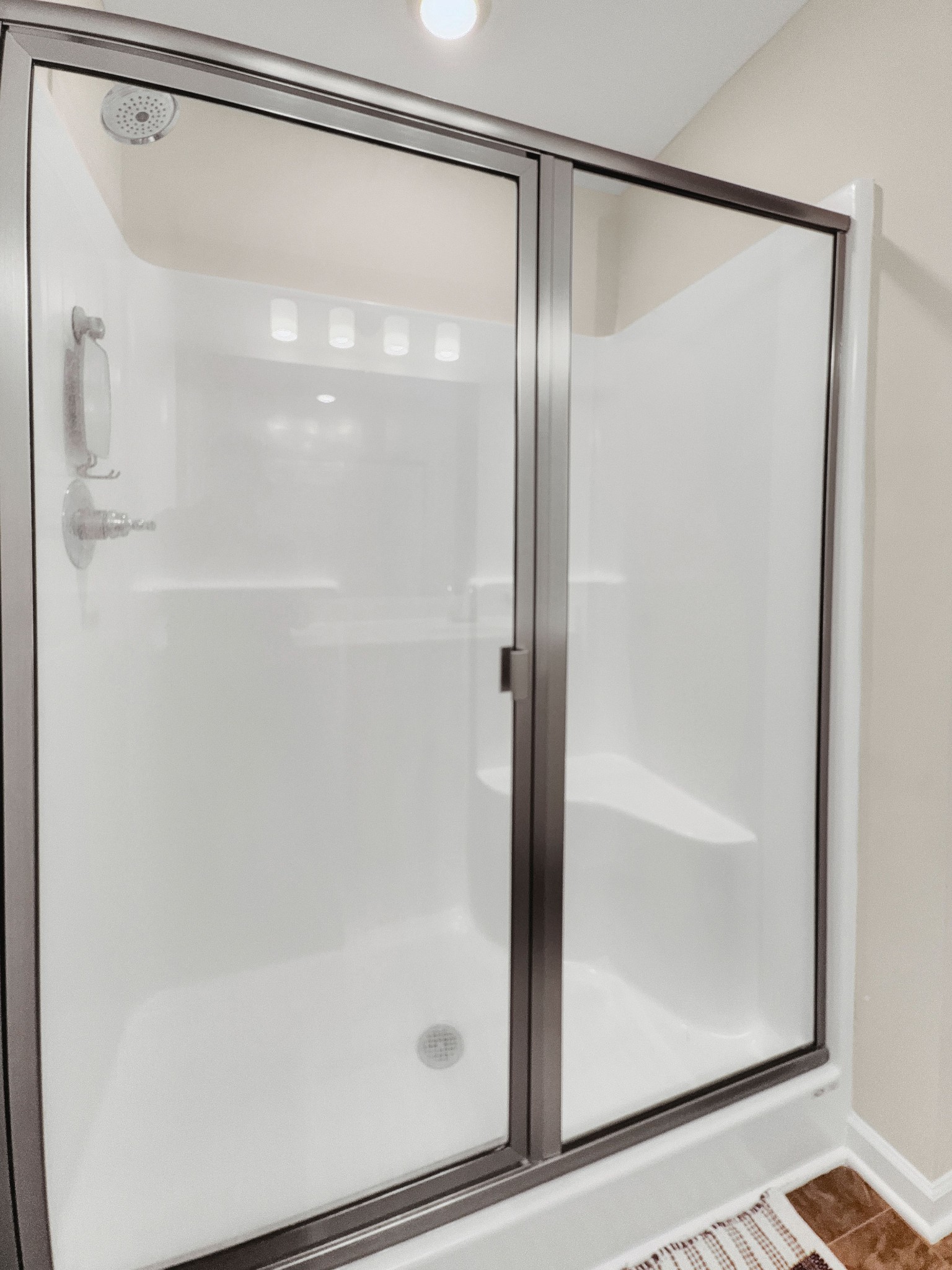 147 Addi Street Pleasant View, TN 37146 - Photo 18 of 26 a bathroom with a glass shower door