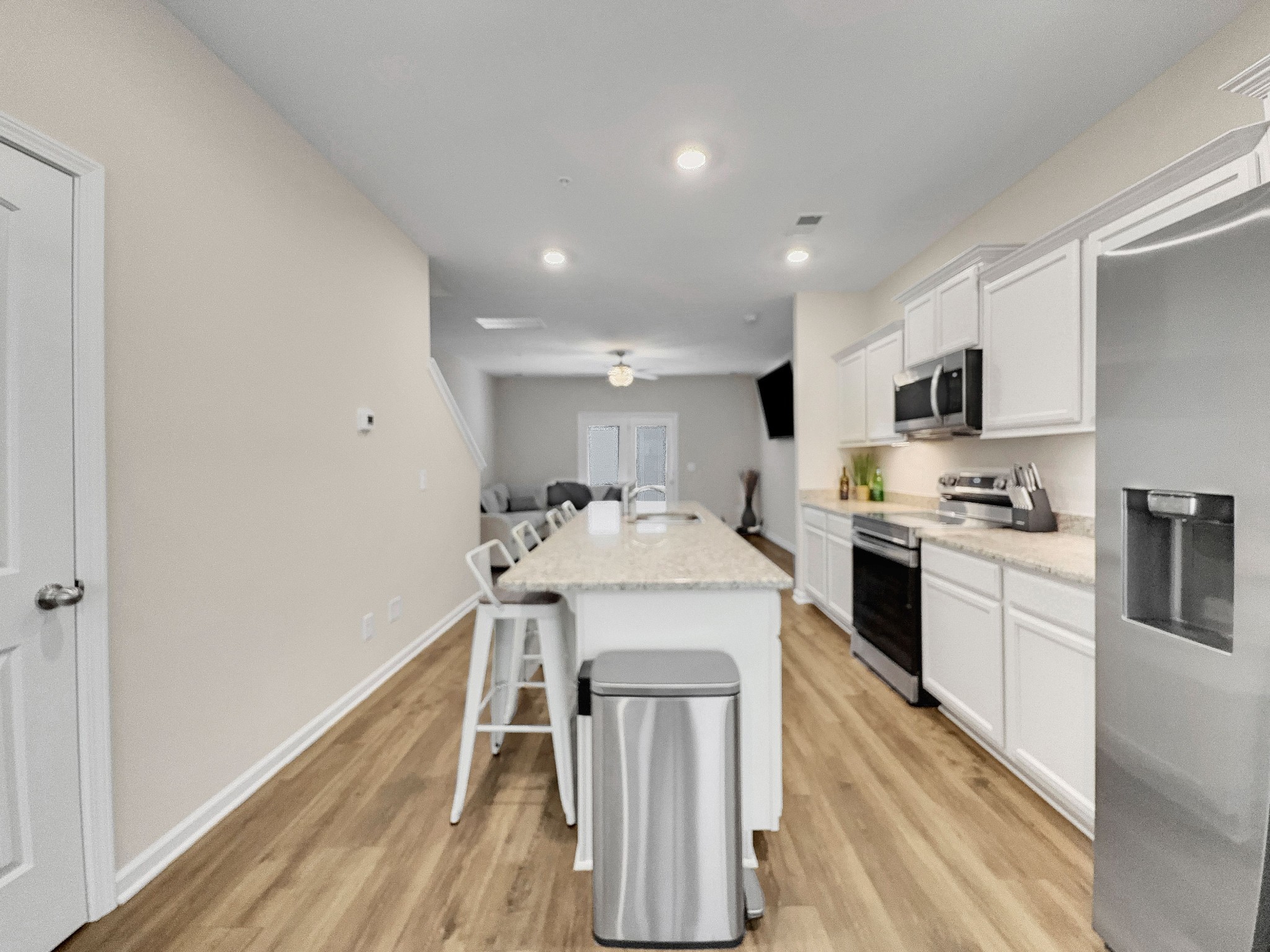 147 Addi Street Pleasant View, TN 37146 - Photo 4 of 26 a kitchen with granite countertop a sink stove and refrigerator