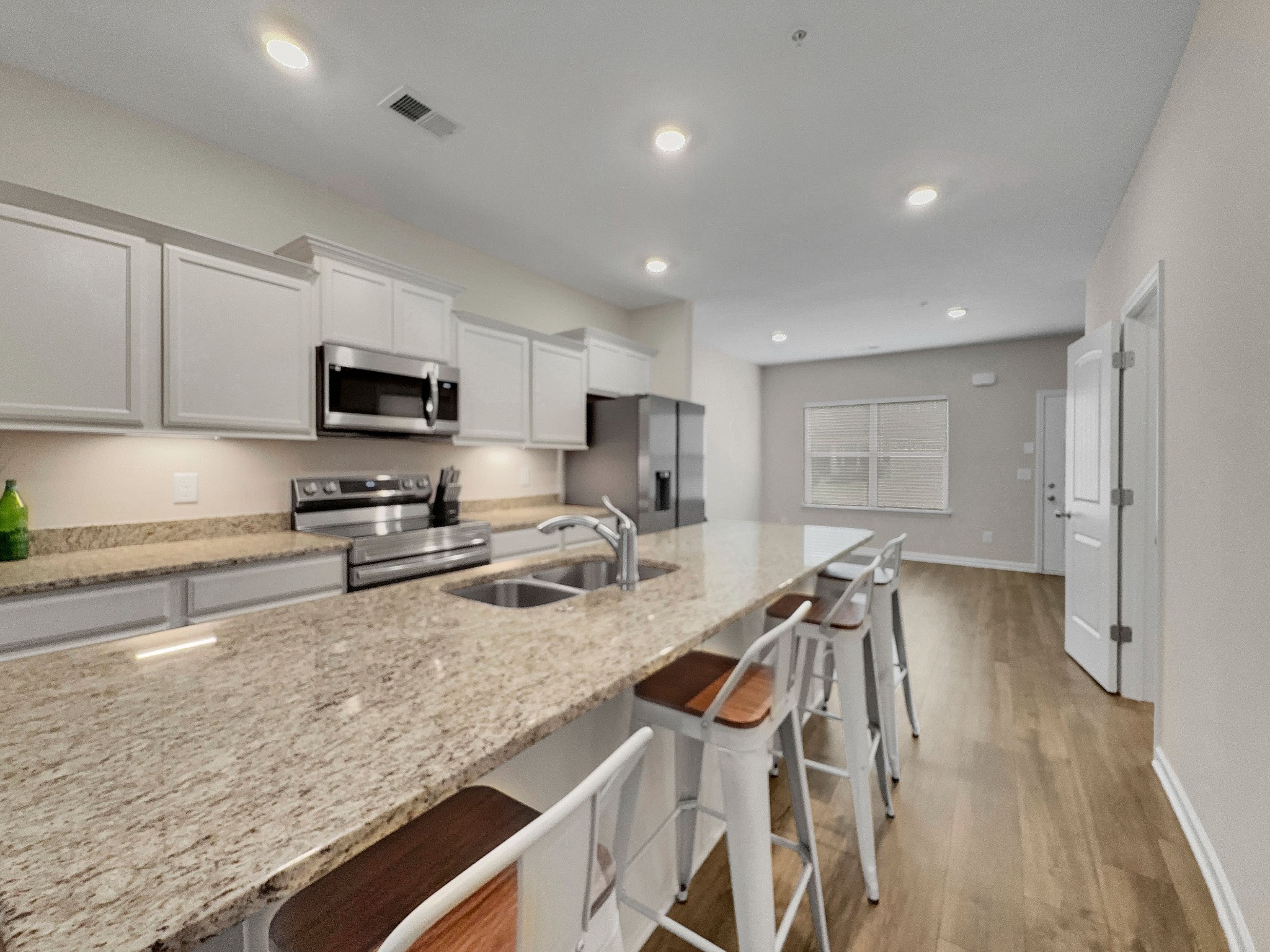 147 Addi Street Pleasant View, TN 37146 - Photo 5 of 26 a kitchen with a sink a counter top space appliances and cabinets