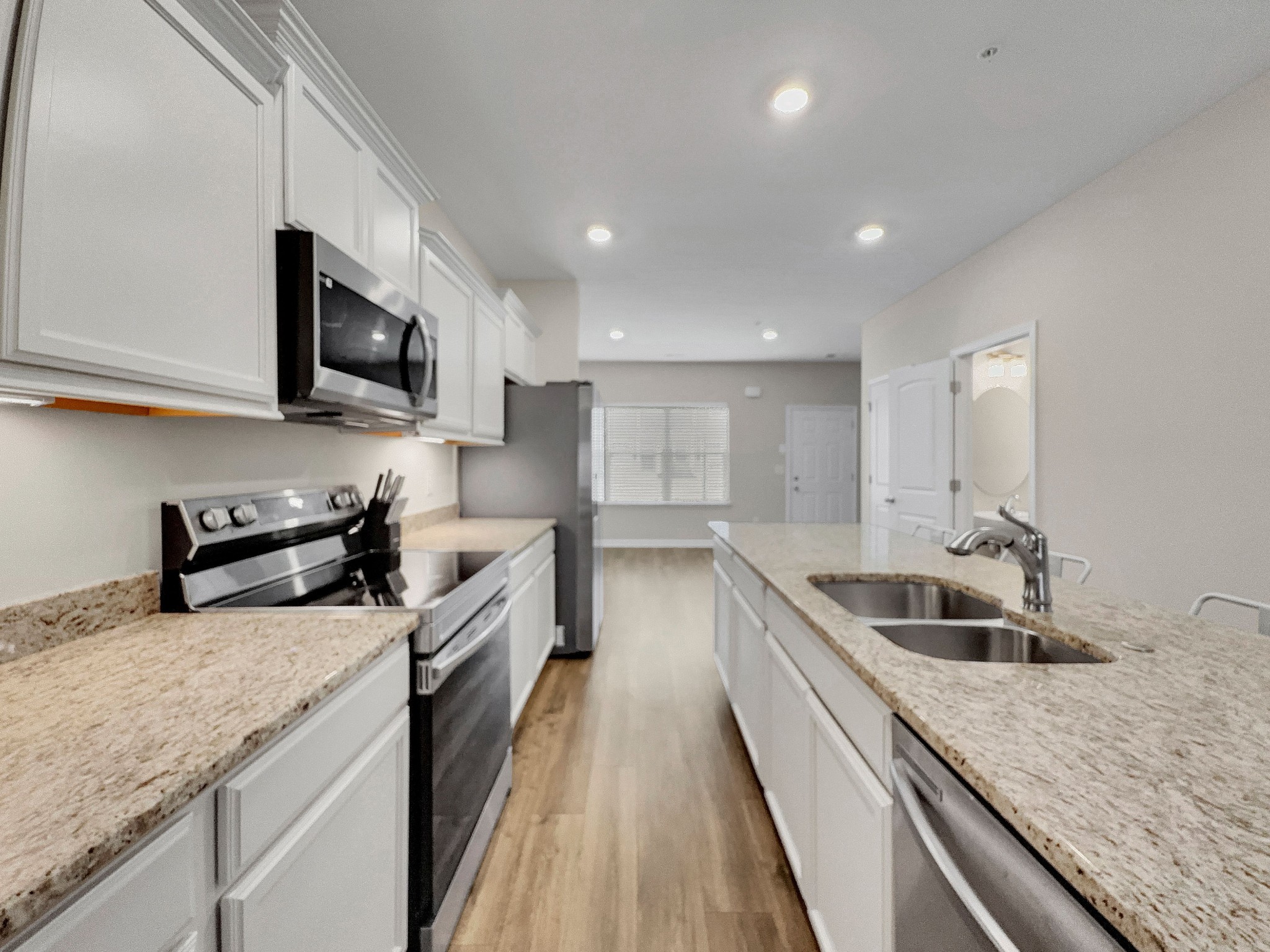 147 Addi Street Pleasant View, TN 37146 - Photo 6 of 26 a kitchen with a sink a counter top space appliances and cabinets