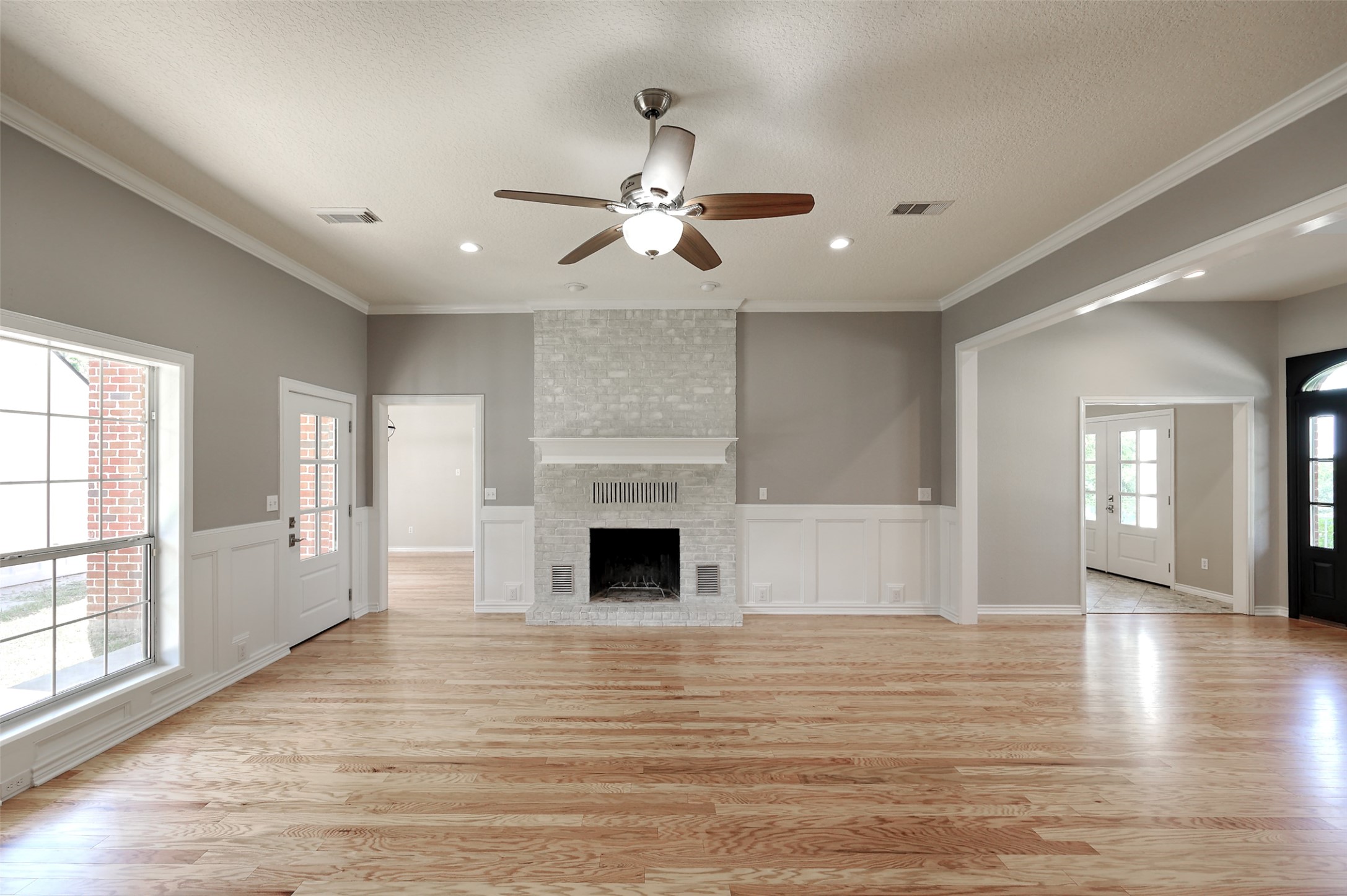 2 Highland Drive Huntsville, TX 77320 - Photo 13 of 50 wooden floor fireplace and windows in an empty room