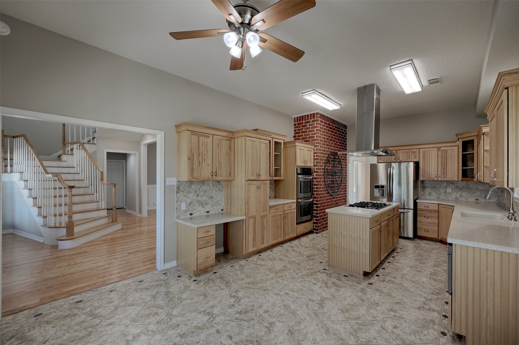 2 Highland Drive Huntsville, TX 77320 - Photo 16 of 50 a kitchen with stainless steel appliances kitchen island granite countertop a refrigerator and a stove top oven