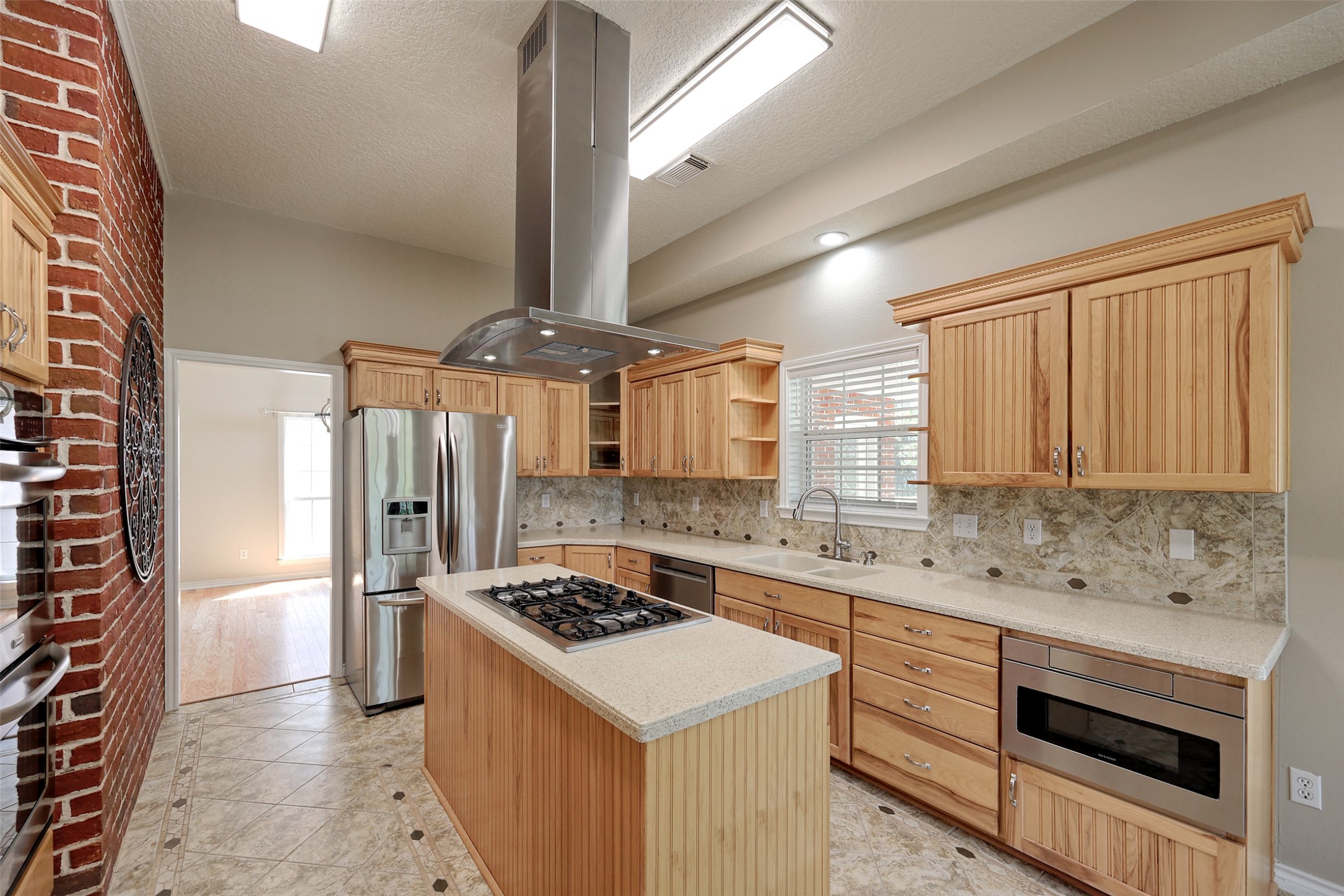 2 Highland Drive Huntsville, TX 77320 - Photo 17 of 50 a kitchen with a stove a sink and a refrigerator