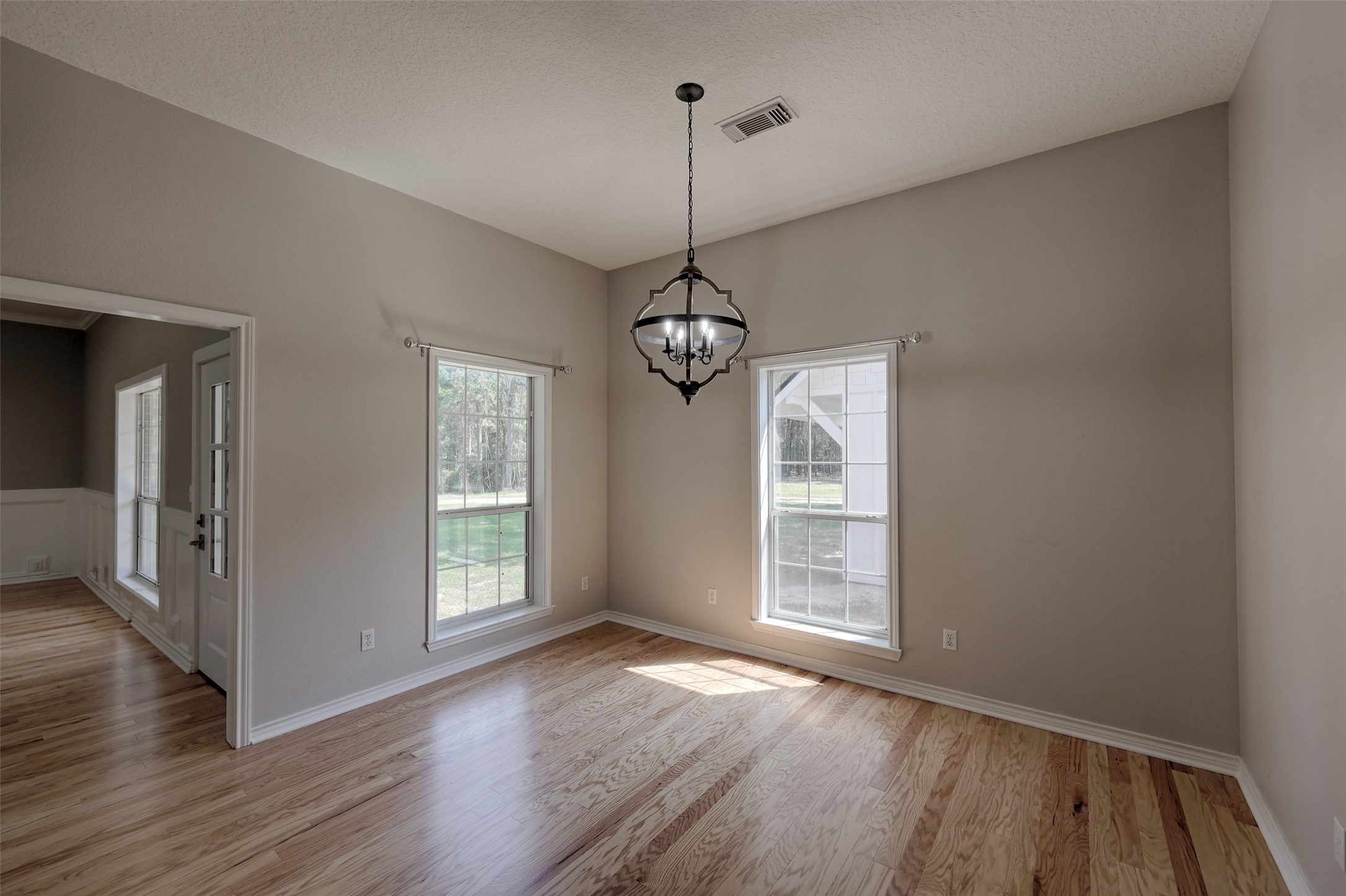 2 Highland Drive Huntsville, TX 77320 - Photo 20 of 50 a view of a room with wooden floor staircase and windows