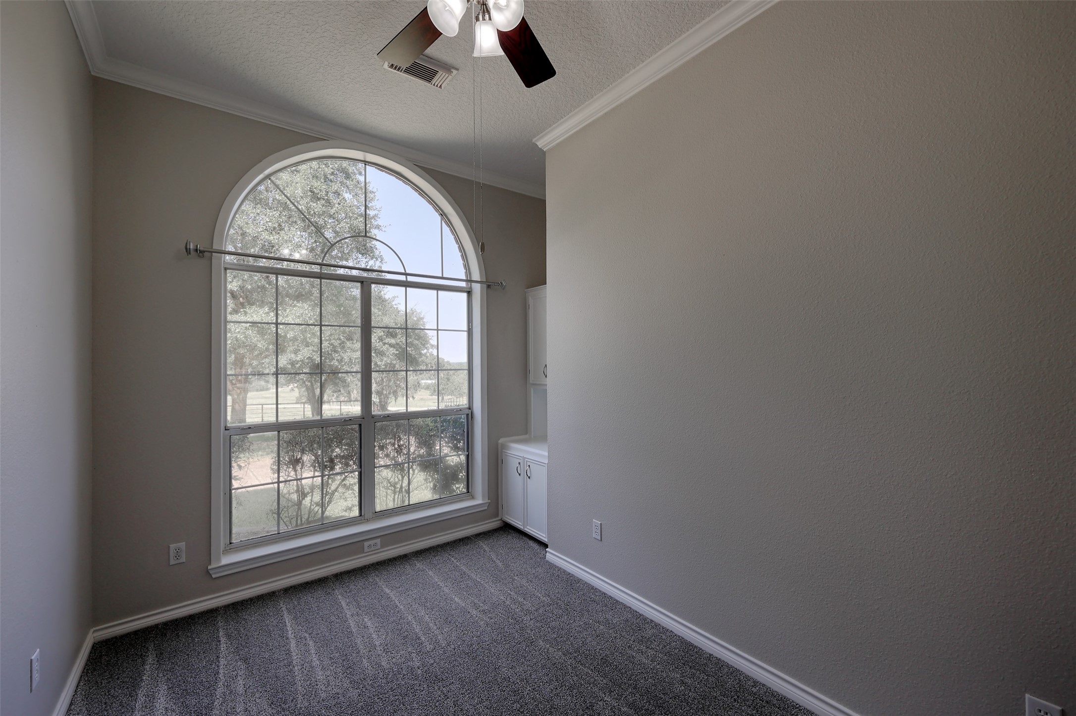 2 Highland Drive Huntsville, TX 77320 - Photo 26 of 50 an empty room with windows ceiling fan and wooden floor