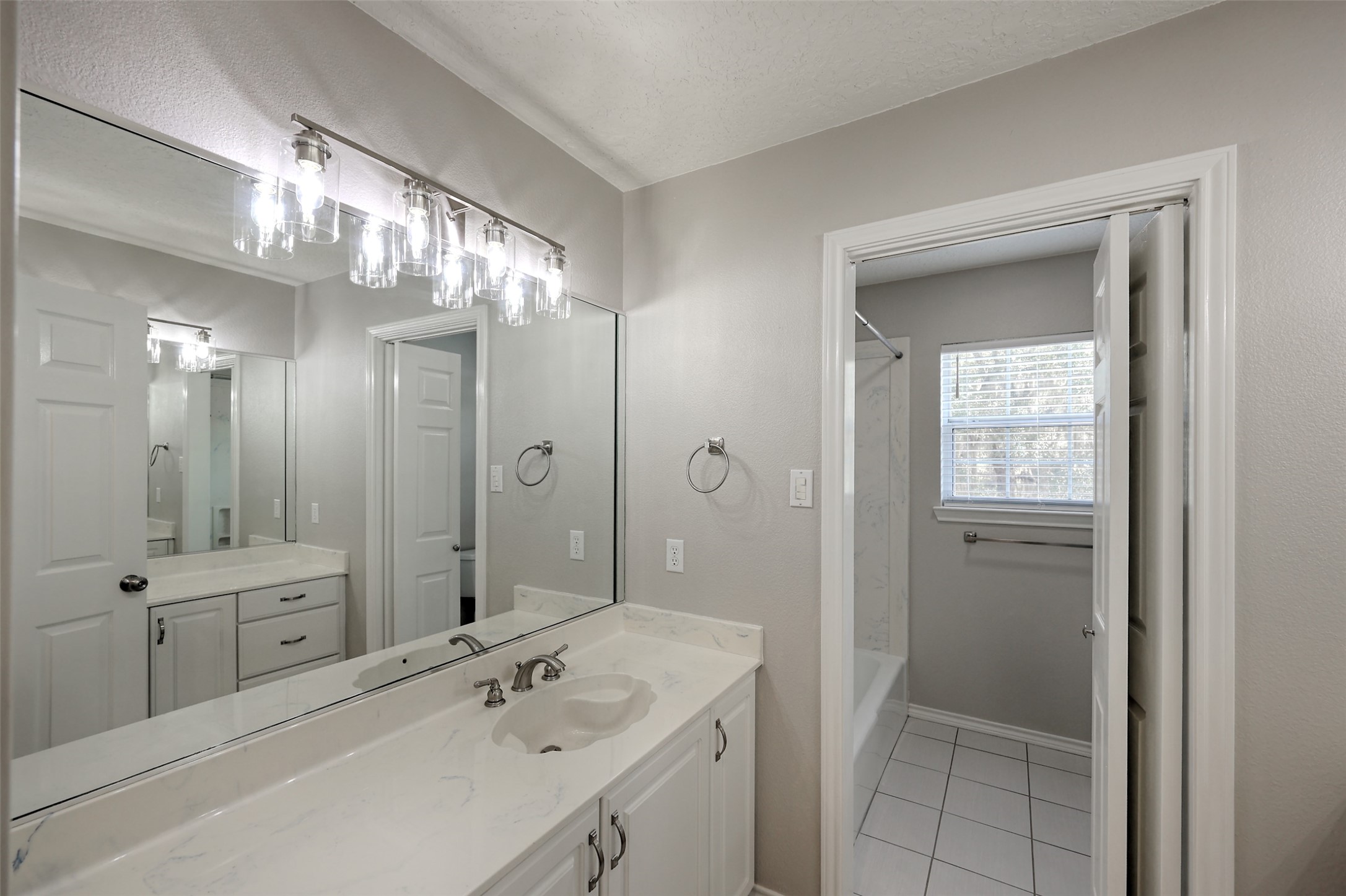 2 Highland Drive Huntsville, TX 77320 - Photo 32 of 50 a bathroom with a double vanity sink and a mirror