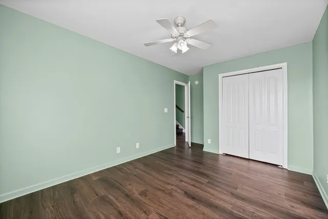 a view of an empty room with wooden floor