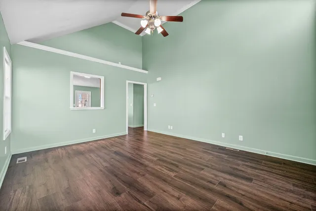 wooden floor in an empty room with a window