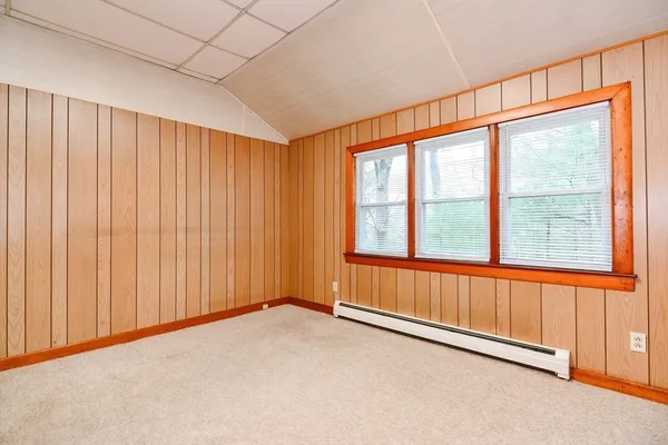 a view of a room with a wooden door