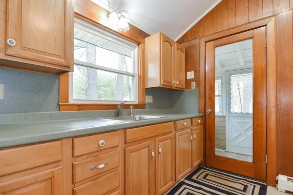 a kitchen with granite countertop cabinets stainless steel appliances a sink and a window