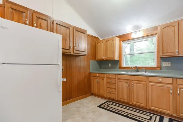 a kitchen with stainless steel appliances granite countertop a refrigerator sink and cabinets