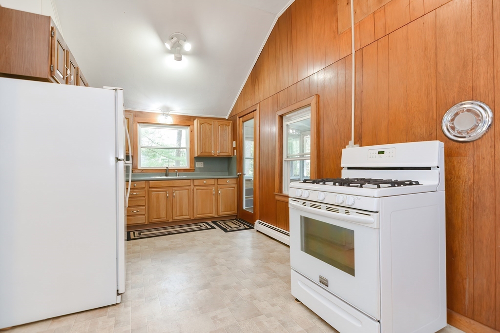 30 Sunset Lane Lunenburg, MA 01462 - Photo 6 of 29 a kitchen with a stove top oven and refrigerator