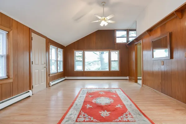 a living room with furniture large window and flat screen tv