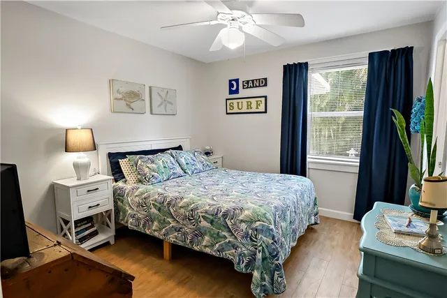 a bedroom with a bed bookshelf and a window