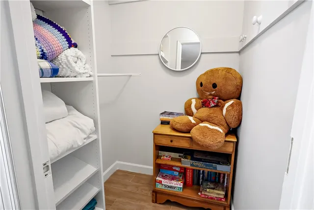 a front view of a room with wooden floor and fan