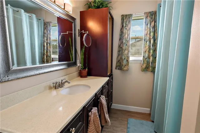 a bathroom with a sink vanity and a mirror