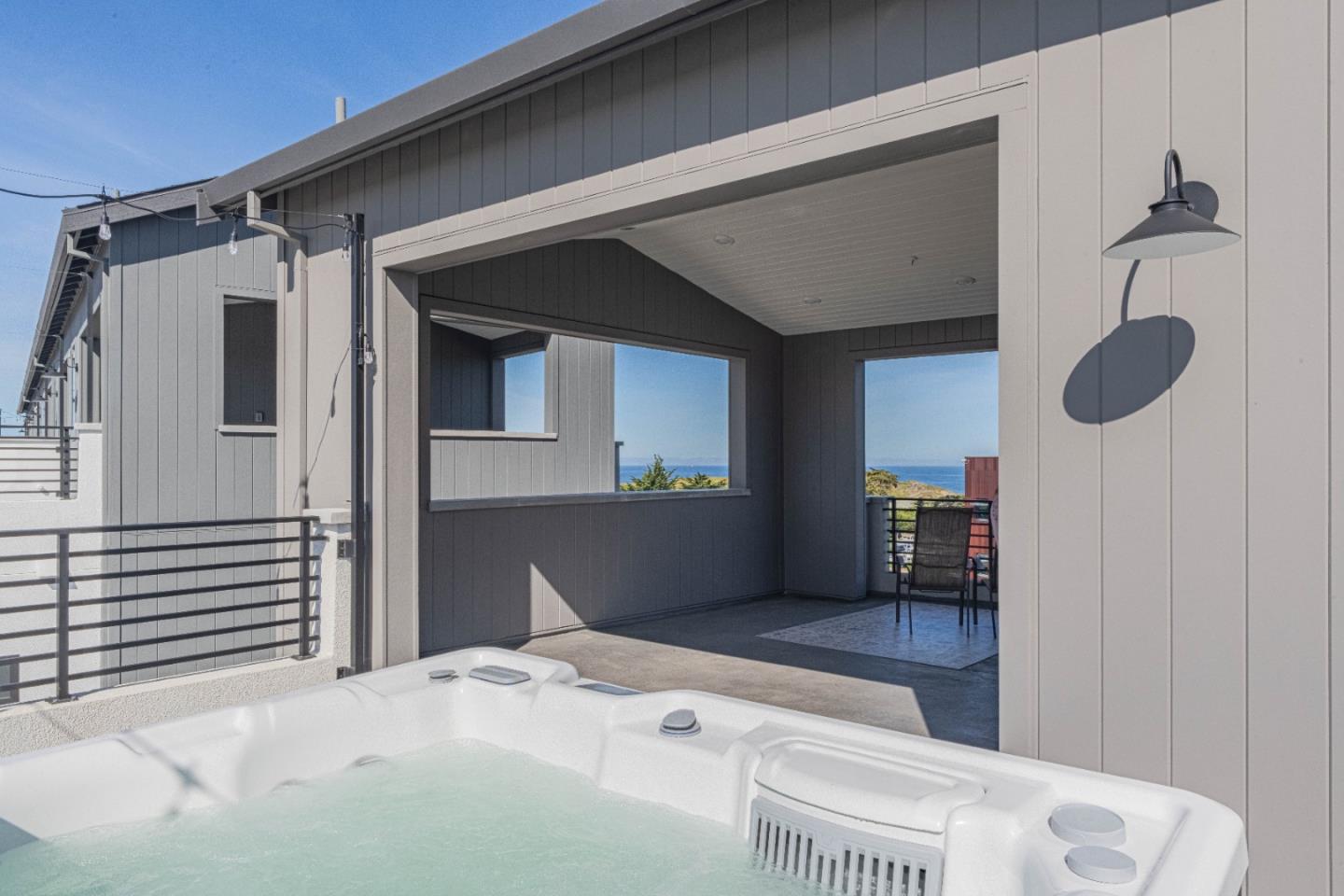 135 8th Street Marina, CA 93933 - Photo 54 of 69 a bedroom with a bed and a chandelier