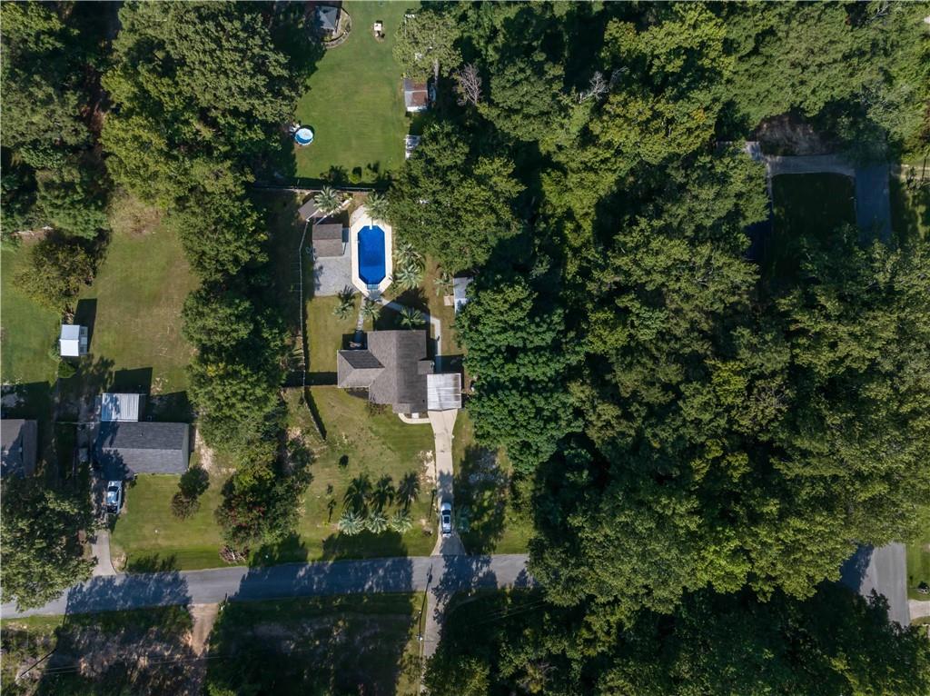 4 Ford Road Phenix City, AL 36869 - Photo 4 of 52 Property featuring a residential structure, a paved driveway, a swimming pool, and mature trees
