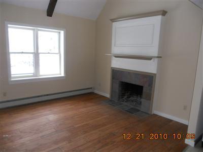 31 Millbrook Road Bourne, MA 02532 - Photo 3 of 6 an empty room with a fireplace