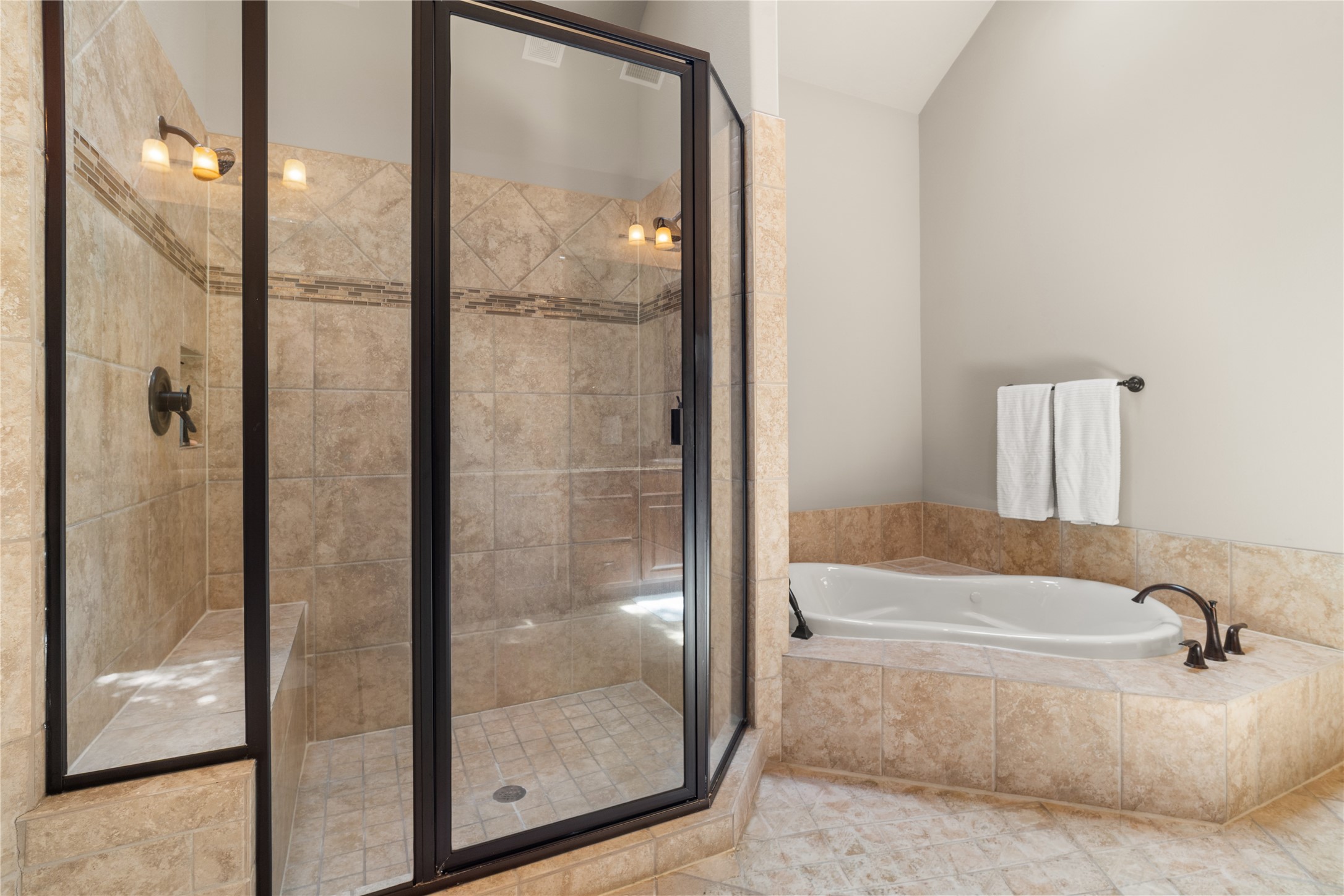19813 Cullen Ridge Drive Porter, TX 77365 - Photo 26 of 44 Indulge in luxury with a spacious walk-in shower and an inviting soaking tub, perfect for unwinding in style.