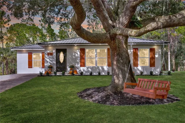 a front view of a house with a garden