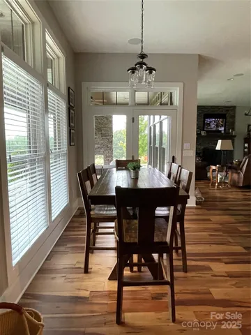 a view of a dining room with furniture window and wooden floor