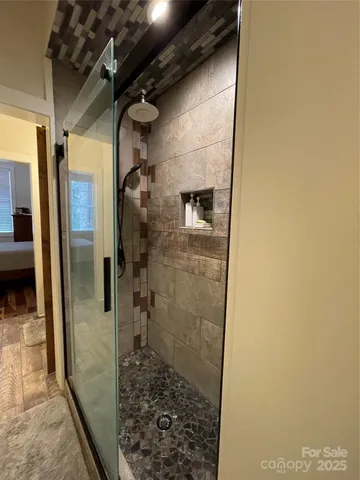 a bathroom with double vanity and a mirror