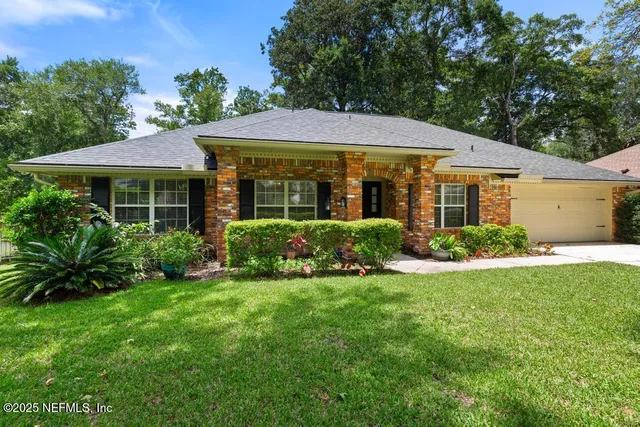 a view of entryway with a big yard and garden
