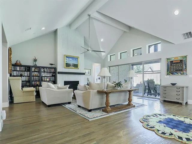 a living room with fireplace furniture and a wooden floor
